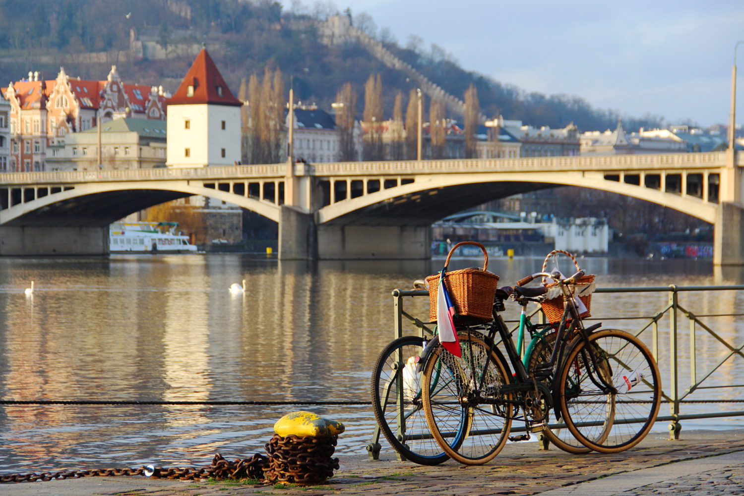 Bikes with baskets by the riverside for cycling from Prague to Budapest