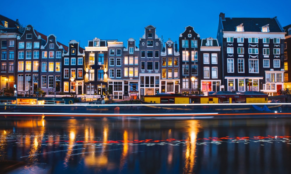 Evening light view over a canal at traditional Amsterdam buildings