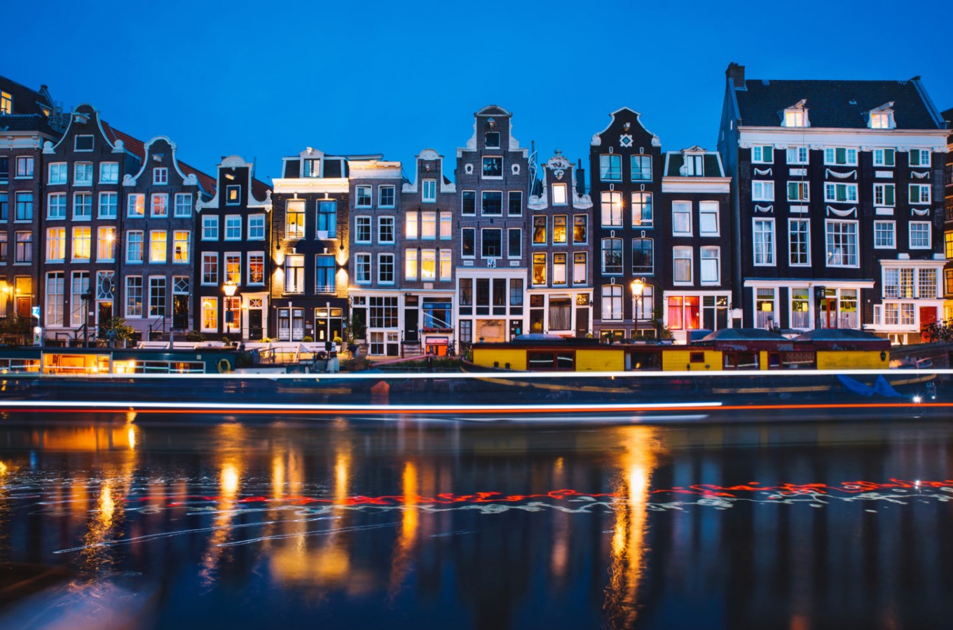 Evening light view over a canal at traditional Amsterdam buildings