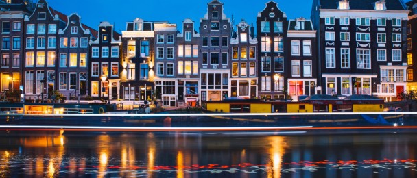 Evening light view over a canal at traditional Amsterdam buildings