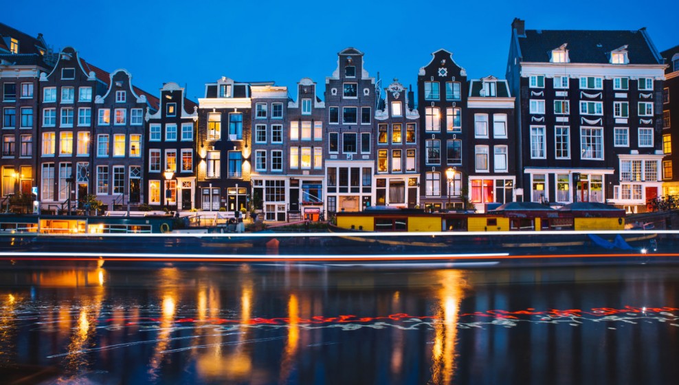 Evening light view over a canal at traditional Amsterdam buildings