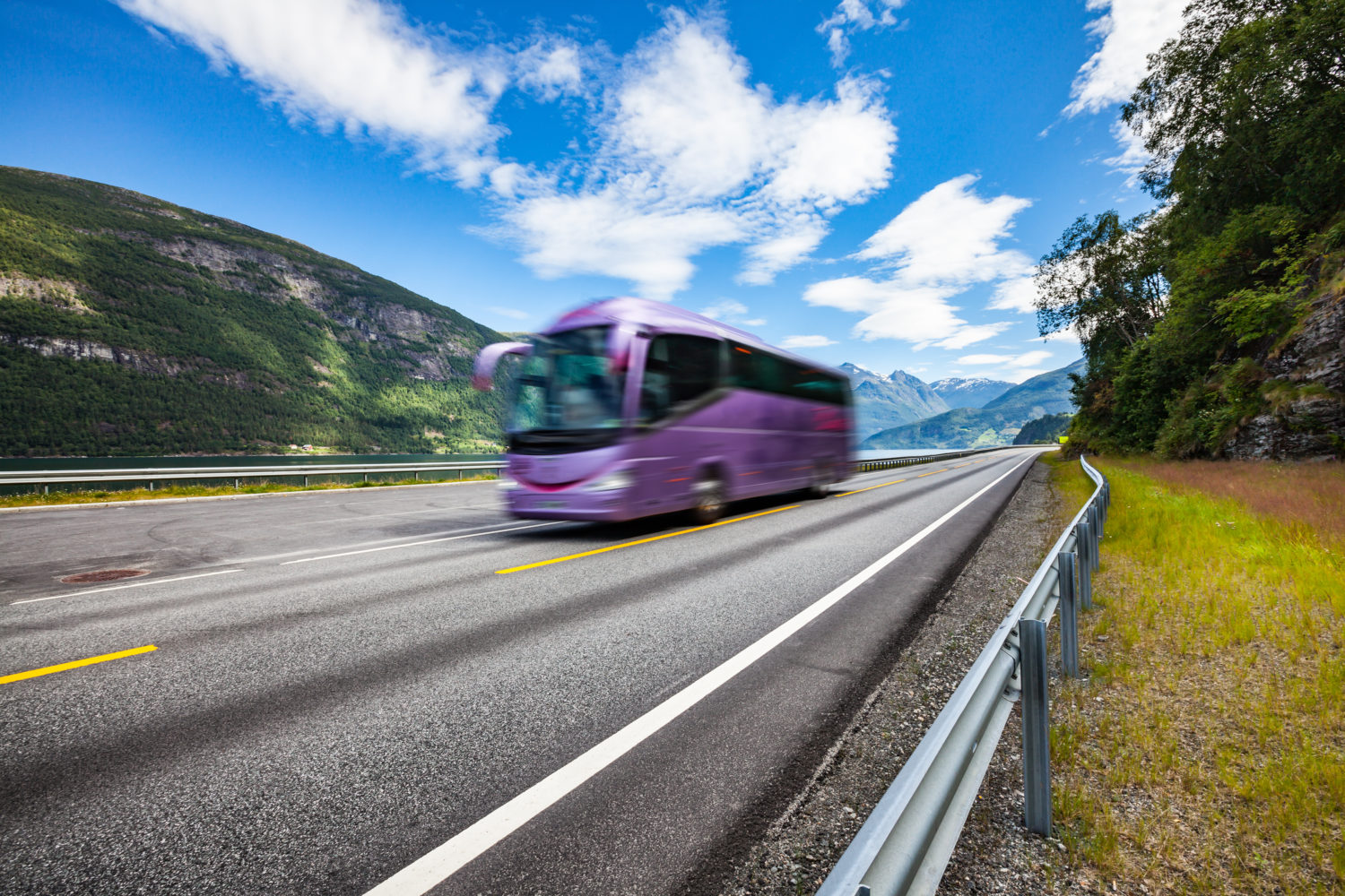 Purple bus on a road going from Prague to Munich