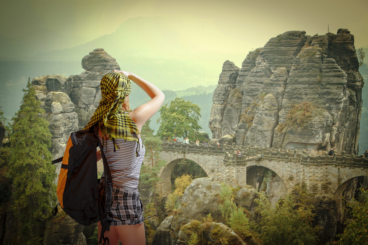 Woman with backpack walking from Prague to Berlin in Saxon Switzerland Germany