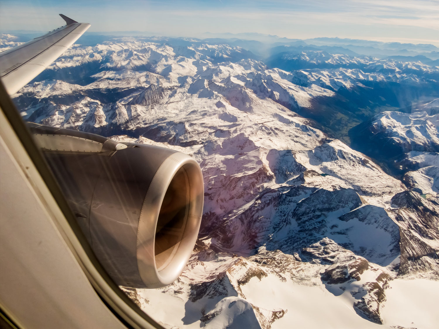 Airplane flying over mountains going from Prague to Vienna