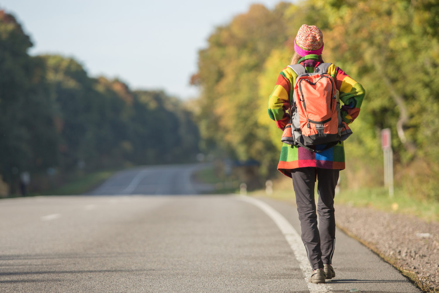 Girl walking on a side of a road and hitchhiking from Prague to Nuremberg 