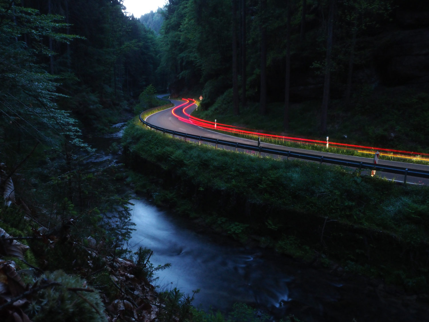 Traffic lights on a road in Elbe Sandstone Mountains while car sharing from Prague to Berlin