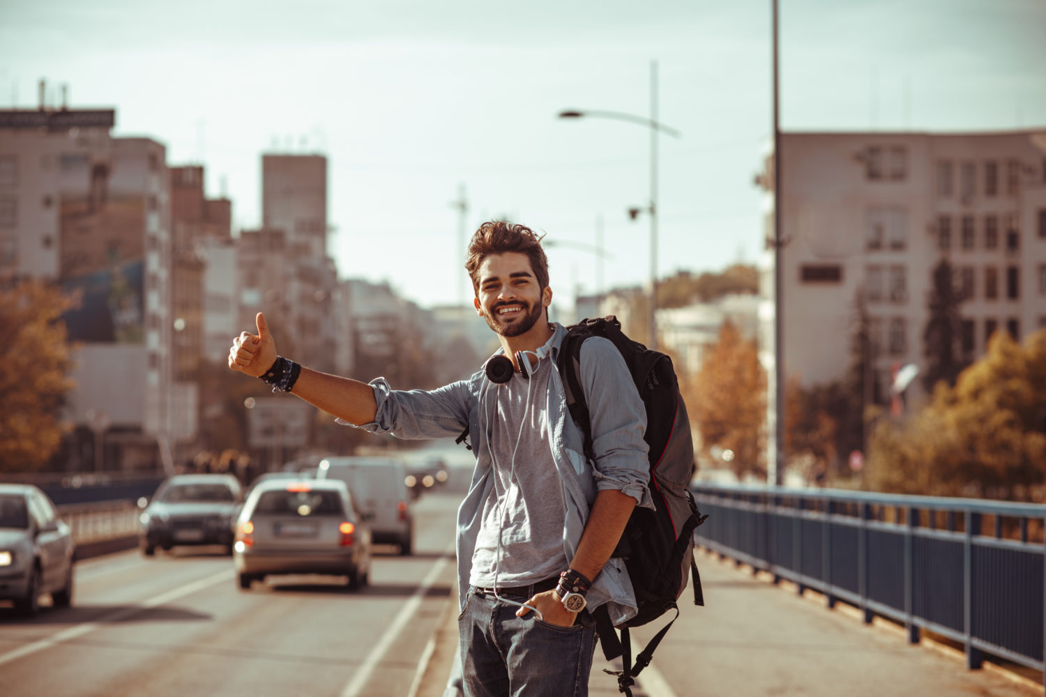 Young man hitchhiking from Prague to Karlovy Vary