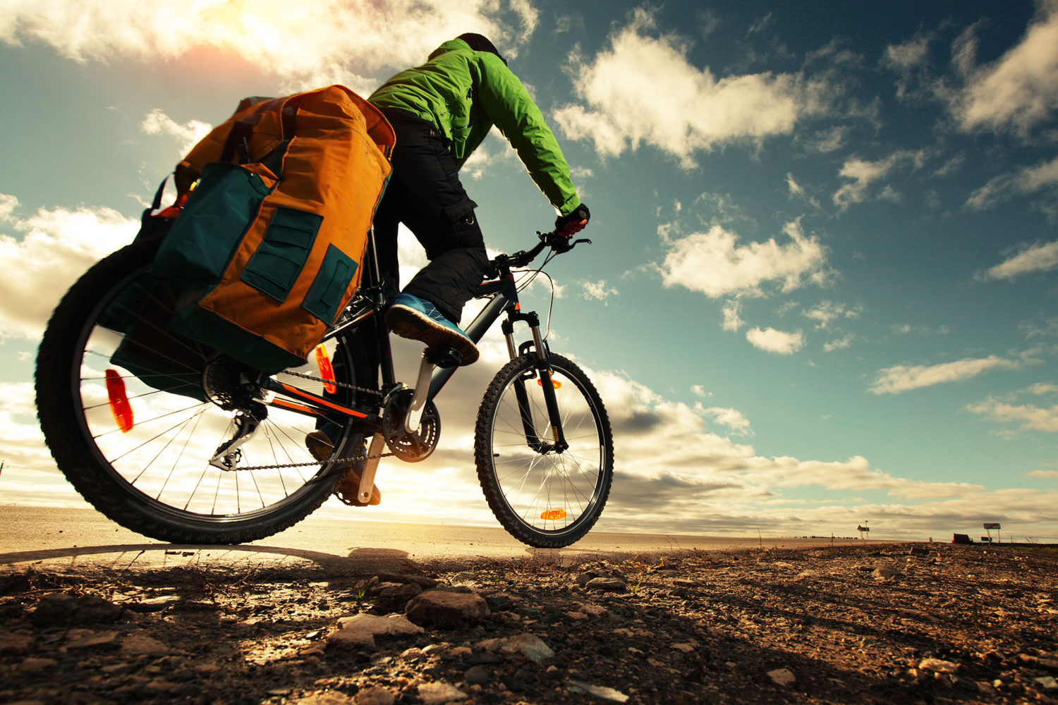 Cyclist with a big bag on a road