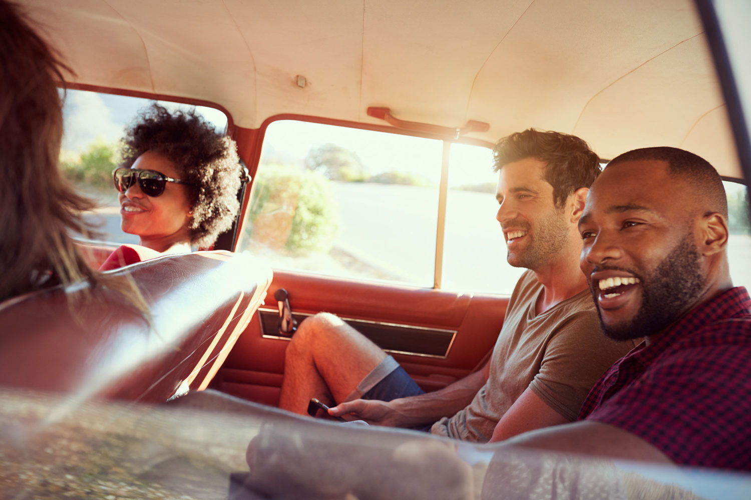 Happy young people sharing a car ride